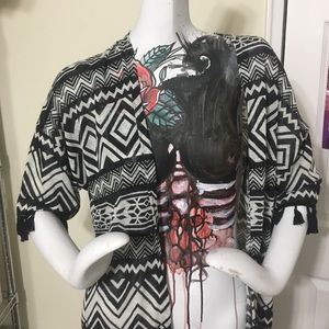 Patterned open front shawl-like jacket.